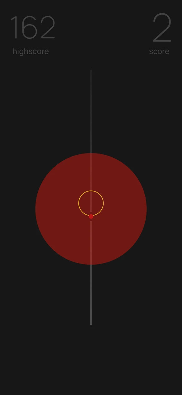 A small circle and dot inside a large red circle on baut’s dark playfield